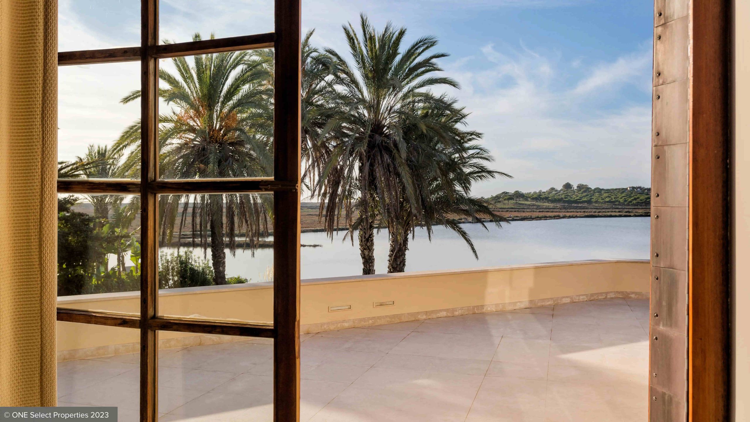 view from a window onto a lake in quinta do lago